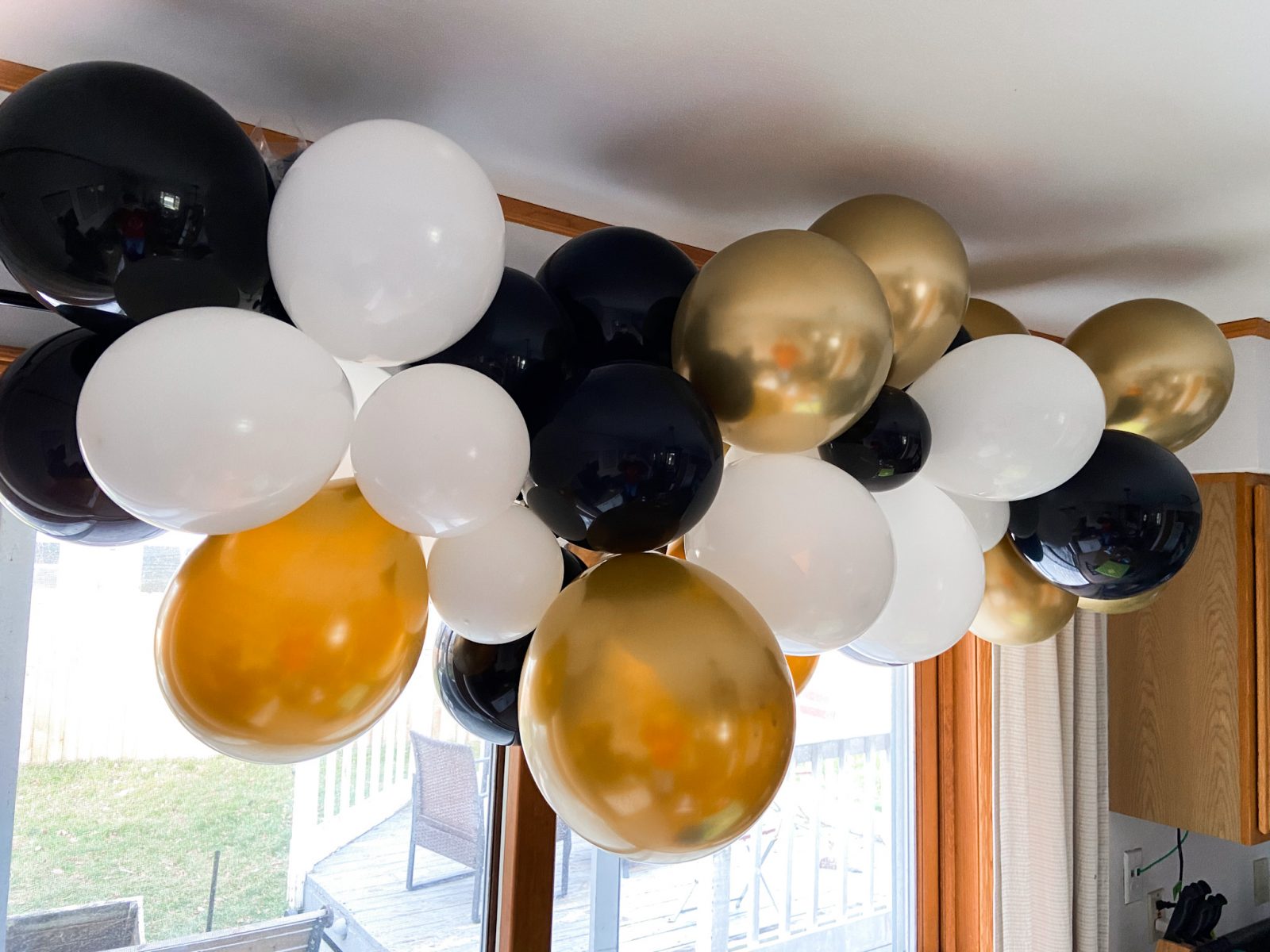 black, white, and gold balloon garland birthday party