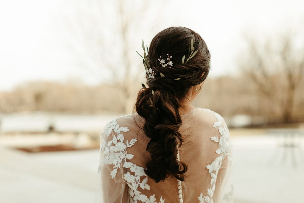 bride with olive branches and elegant lace dress
