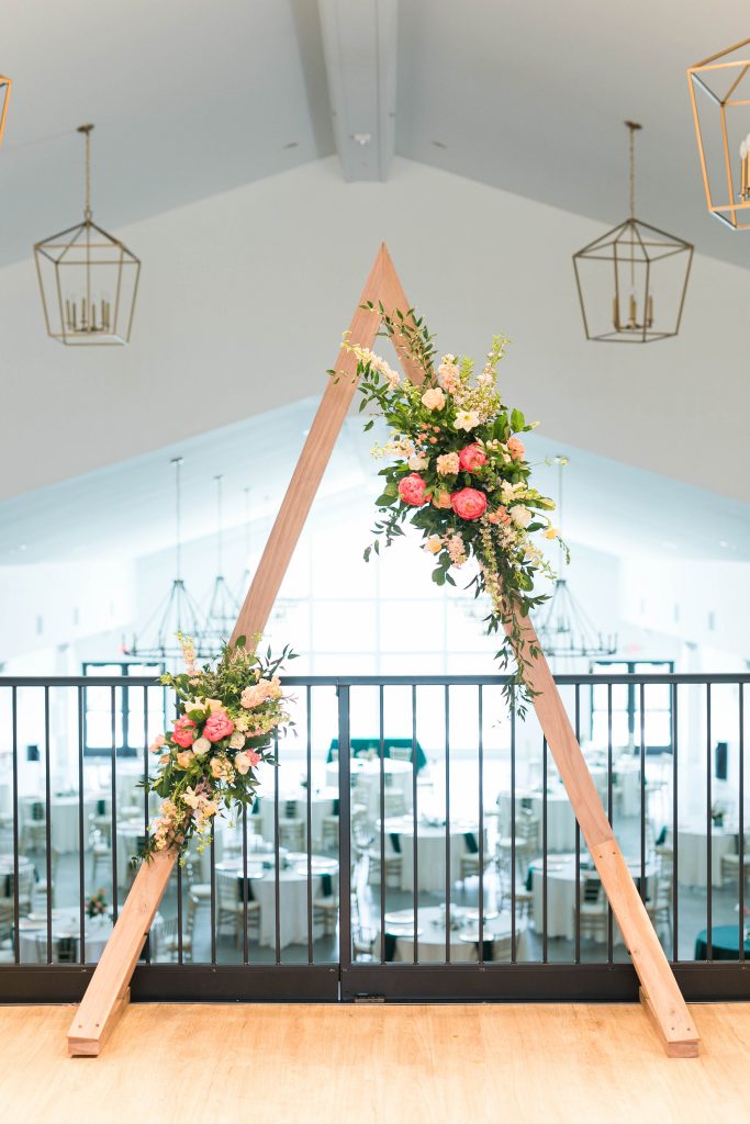 emerald and pink wedding arch rental