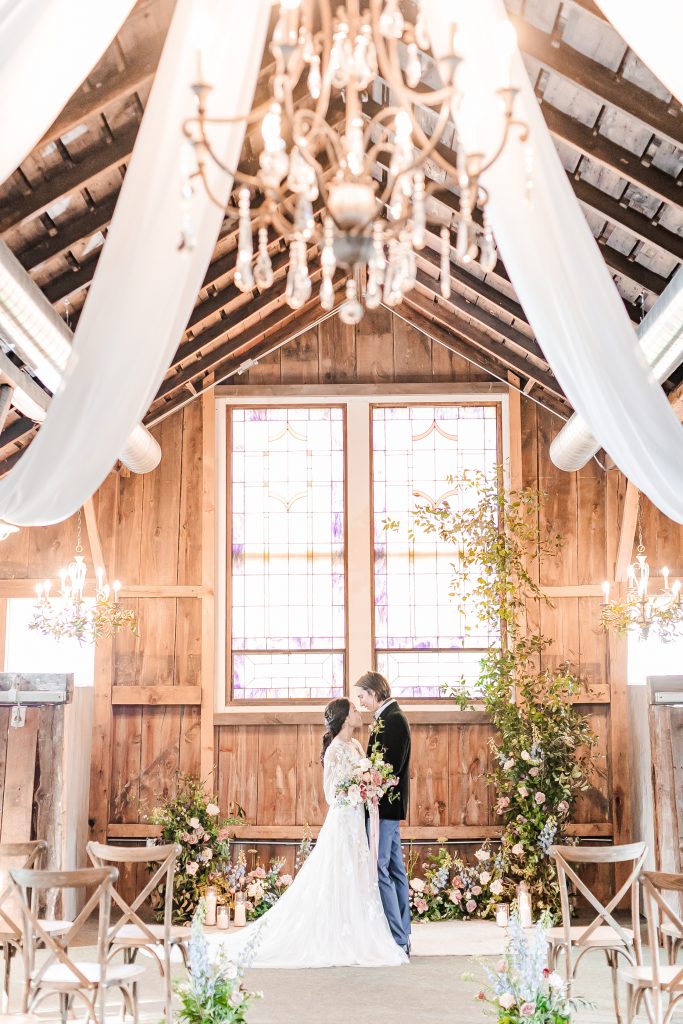 Ceremony stained glass draping and lush trailing floral